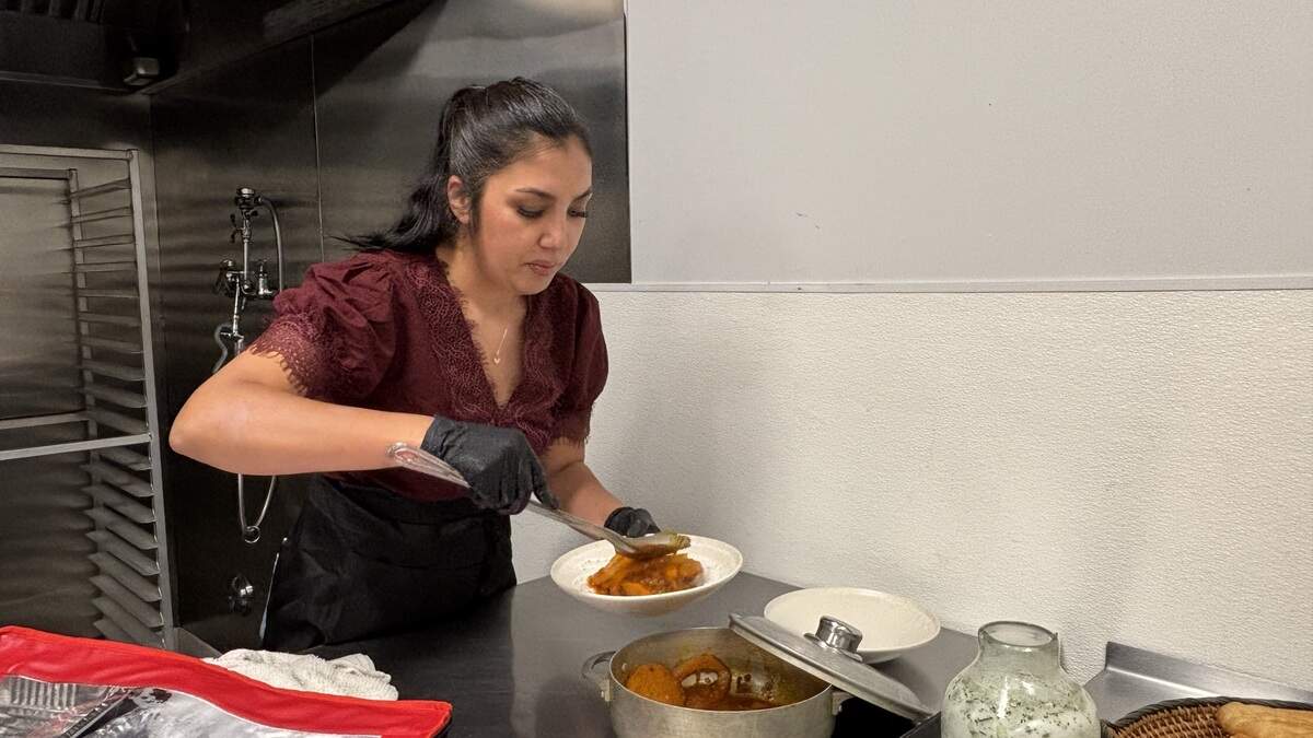 Owner of Kor Kitchen Sophia Zekria spoons out borani kadoo, a classic Afghan dish featuring squash and spices. Owner of Kor Kitchen Sophia Zekria spoons out borani kadoo, a classic Afghan dish featuring squash and spices.